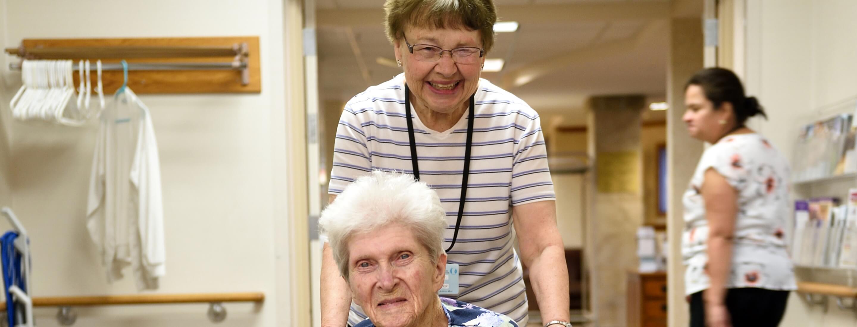 caregiver pushing someone in wheelchair